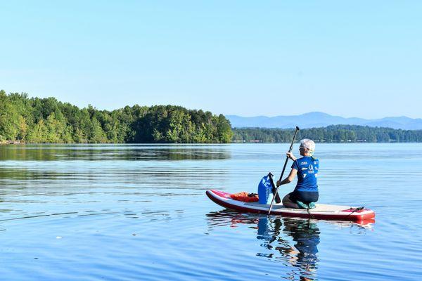 Paddleboarding at Lake Robinson with the North Carolina mountains in the background.