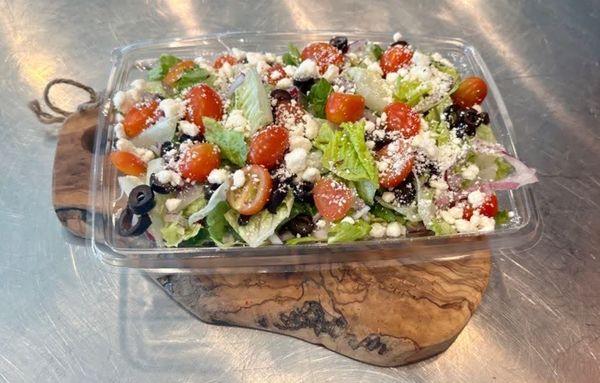 Antipasto Salad: Tomatoes, red onions, black olives, and feta on a bed of romaine lettuce. Served with our housemade citrus vinaigrette.