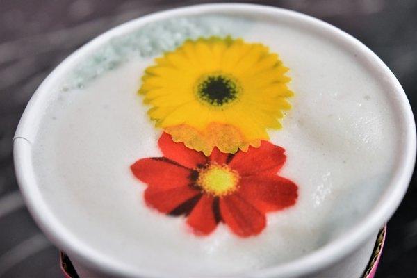 Blue vanilla chai latte with edible rice paper flowers.