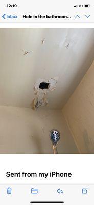 Picture of an hole in bathroom ceiling made months ago by the office due to a leak from upstairs .