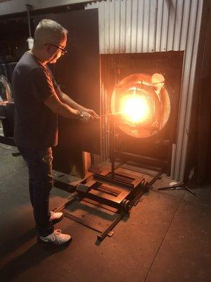 Phil at the glory hole. It's a furnace used to keep the glass workable.