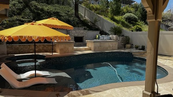 Wider view of pool and seating area.