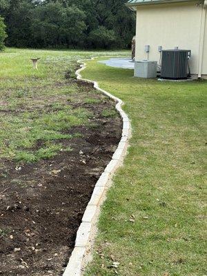 Cream chop block curbing around sod.