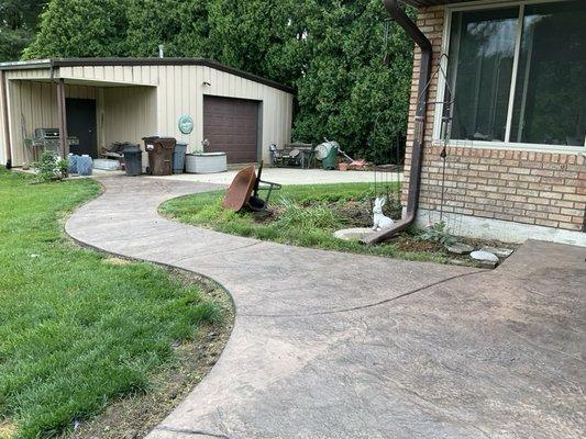 Colored, stamped concrete curving walkway