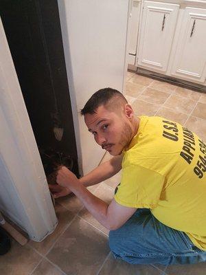 My Technician Repairing a Refrigerator.