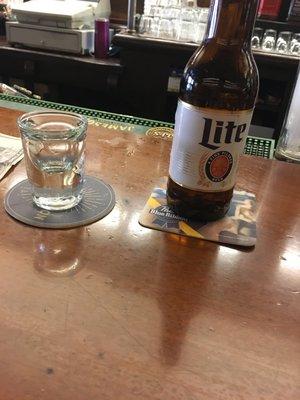 Lite beer and an empty shot glass, to be refilled.