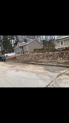 Natural stone retaining wall.