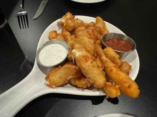 Cheese curds in yellow and white cheese.