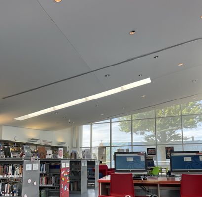 Interior glimpse facing the children's section and the outdoor terrace.