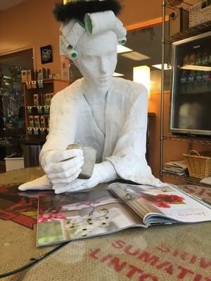 Quiet table mate.  The coffee might be good, but perhaps she should drink less of it and get more sun.