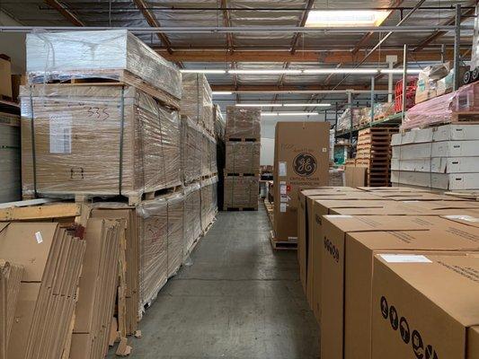 Inside our Warehouse. Pallets of Solar Panels, Telecom Batteries and Telecom Cabinets.