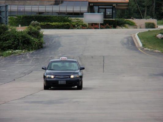 Naperville Taxi # 007 entering a commercial Parking Lot