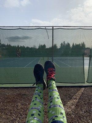 Swinging while watching the courts.