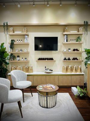 Honey Care Spa reception area with plant-based retail skincare products for purchase.