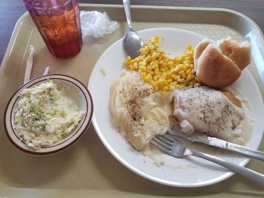 The fried chicken breasts, mashed potatoes, corn, coleslaw, and a homemade roll