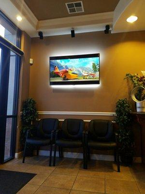 Comfortable seating pleasant clean kid friendly waiting lobby always playing popular family/kid movies to keep patients/company entertained