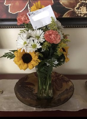 $63.00 daisies, carnations and 2 sunflowers.