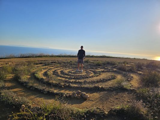 A Labyrinth near the bench on the west side of the trail.