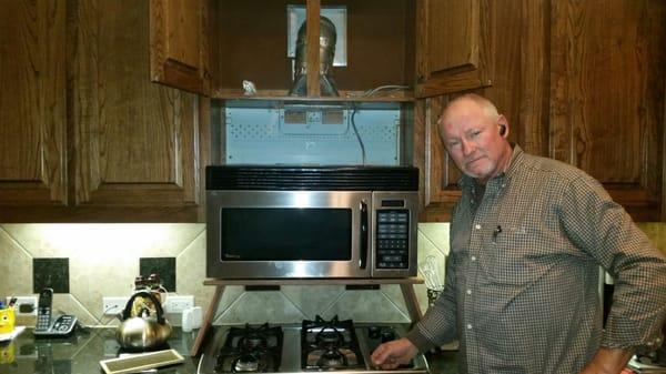 Larry Garner working on over the counter built-in microwave unit.