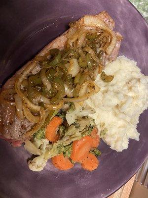 Ny Strip Steak topped with Peppers and Onions , served with Garlic mashed and Sauté Mixed veggies