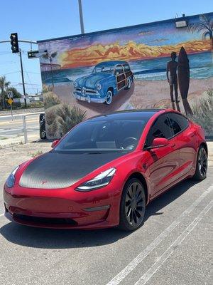 Dry carbon hood wrap with red Tesla hood emblem