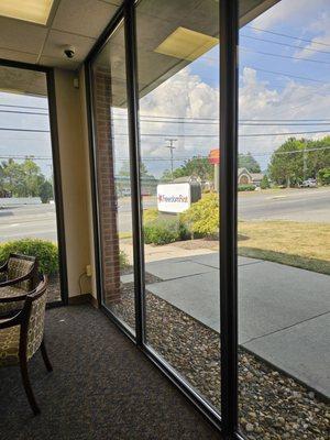 The entrance is surrounded by glass walls.