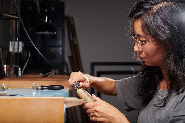 In the jewelry studio, using the jeweler's saw, stamping materials, and flex shaft.