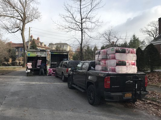 Unloading Owens Corning insulation at the job site.