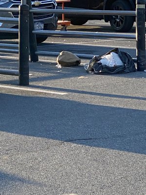 Gun Hill Road location, garbage in parking area strewn about.