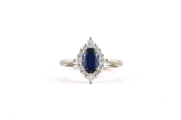 Item #800-2734: 1.04 carat Oval-cut Montana Yogo Sapphire with a Stylized-halo of Diamonds, Platinum A Stunner.