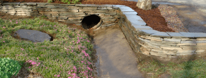 This drainage project began as an ugly duckling but with a little love and creativity it was transformed into something beautiful.