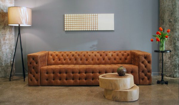 Brown sofa and wooden slate table available at Sloane Square.