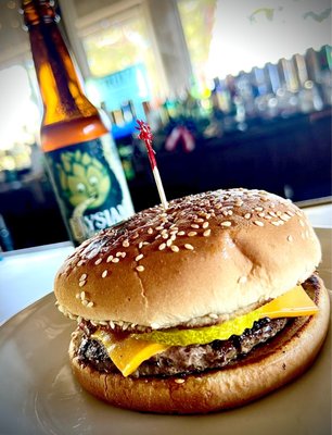 Uriels simple burger con melted queso with grilled onions and pickles.