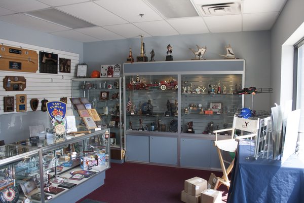 Inside our showroom, with various samples of awards we offer.