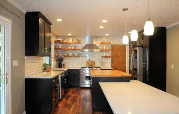 Hamden Kitchen After - Shaker black cabinets, Oak butcher block island with attached unique dining table with quartz top.