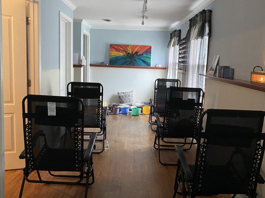 Reclining chairs set up in the Mindful Moon studio for a sound healing event.