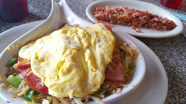 Fluffy eggs on top of ham, hashbrowns, peppers, onions and mushrooms. A delight. Corn beef hash in the back!