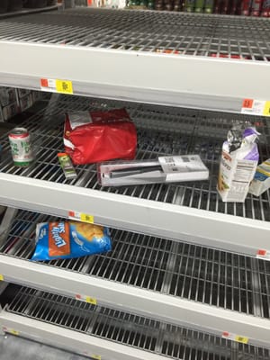 This is the shelf where for over 1 week, there has been no gallon bottles of water. Instead,  it is being used as a trash receptacle.