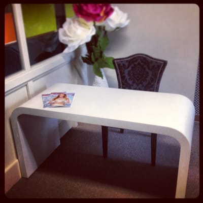 Contemporary office desk made in white concrete.