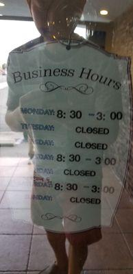 Their business hours are listed on the tinted black door. Hard to see Eh?