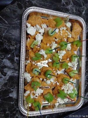 Buffalo chicken bites with celery and crumbled bleu cheese.