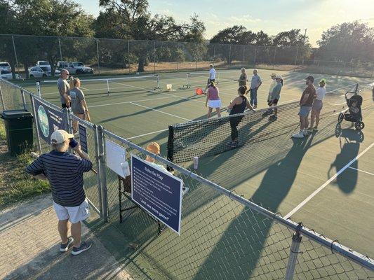 4 Pickleball courts with a divider net to catch stray balls.