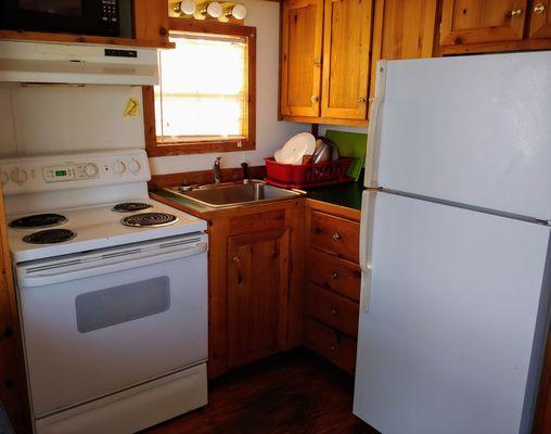 Good sized kitchen! Has the basics, plates, cups, silverware, etc. Pots and frying pans were unusable. Caked on food and too scratched up.