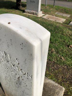 Veteran's headstone amongst other types of memorials.