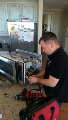 Jordan Garner working on microwave.