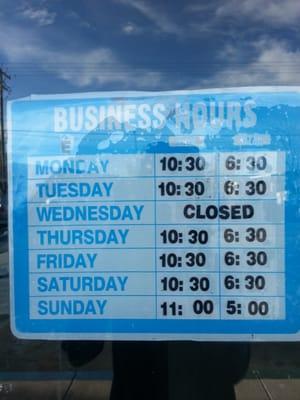 Business Hours hanged at the door of Shaban Mart.