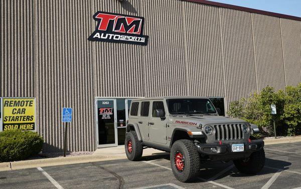 TM Autosports store front with Jeep Wrangler modified with larger wheels/tires, window tint, suspension modifications, and audio upgrade.