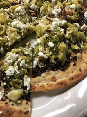 Cauliflower crust pizza with shaved Brussel sprouts, goat cheese, bacon & balsamic glaze