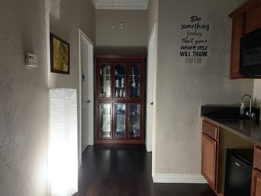 Hallway with bathroom and several different massage rooms