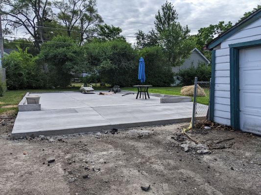 Garage pad, several wks later.  Looks great.  K&K  laid grass seed where hay stack is.   With watering the grass is growing in nicely.